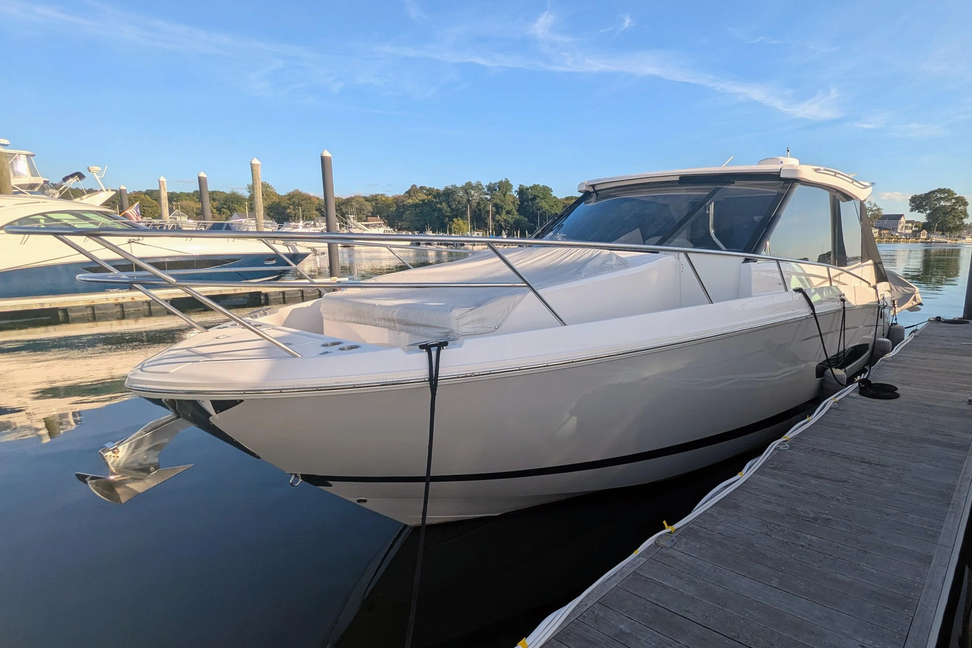 2021 Regal 36 Grande Coupe docked at marina under clear blue sky.
