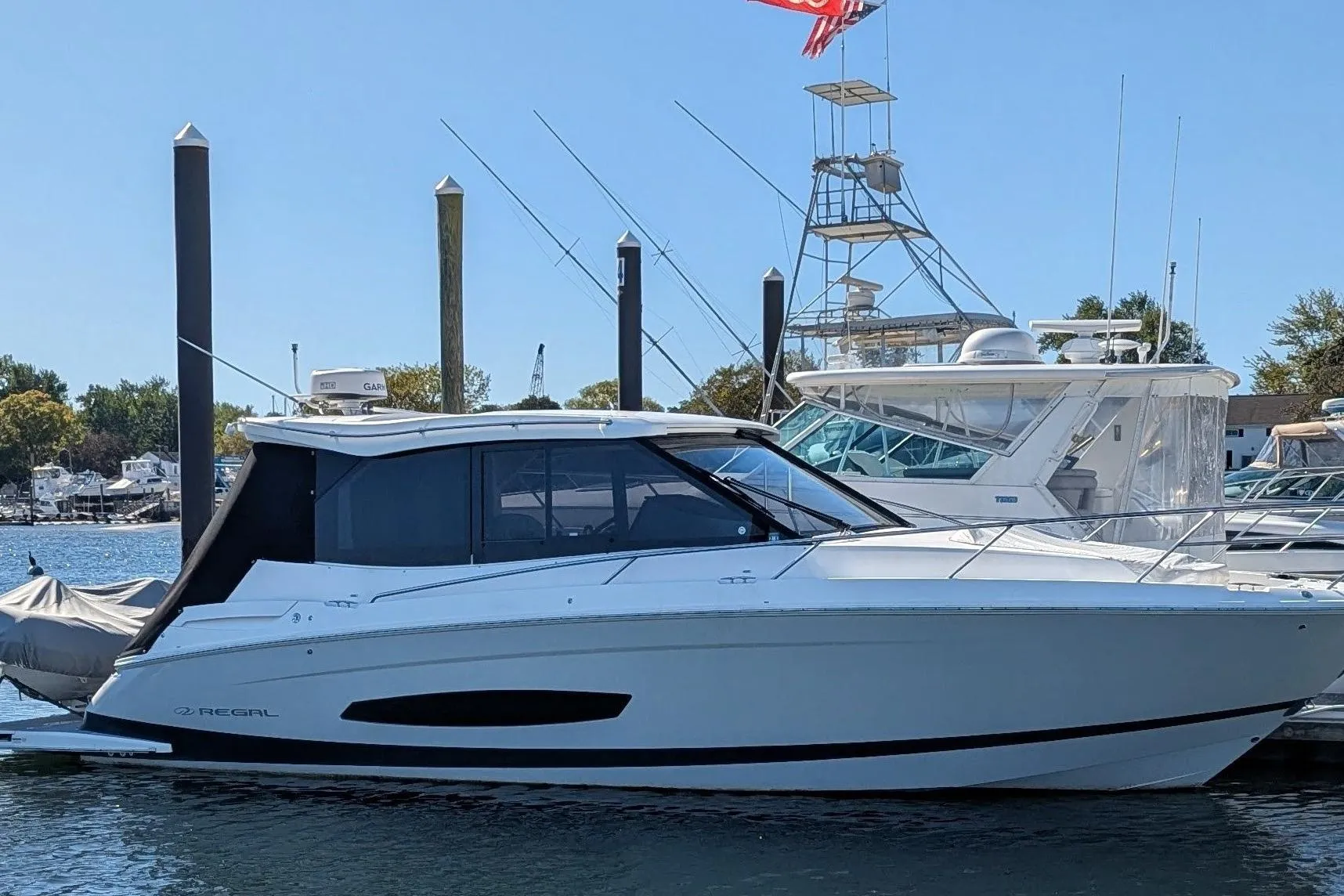 2021 Regal 36 Grande Coupe yacht docked at marina, side view.