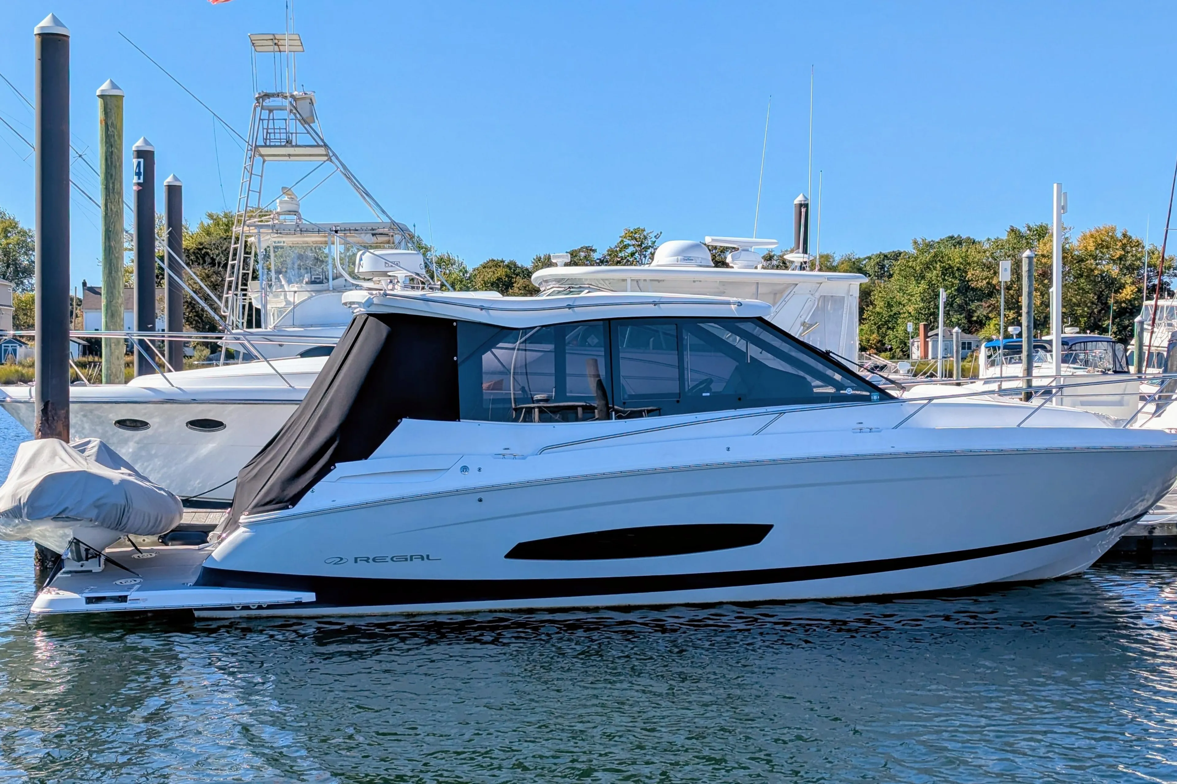 2021 Regal 36 Grande Coupe yacht docked at marina, side view.