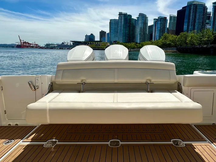 Blue Reeler Yacht Photos Pics 2023 Boston Whaler 405 Conquest boat with city skyline in background.