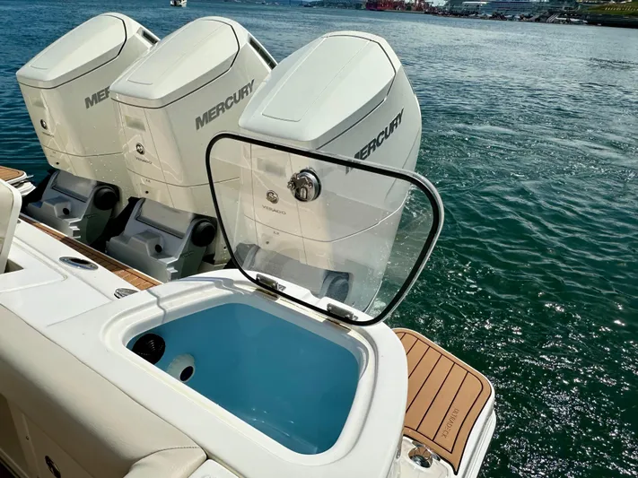 Blue Reeler Yacht Photos Pics 2023 Boston Whaler 405 Conquest with Mercury engines and open livewell on deck.