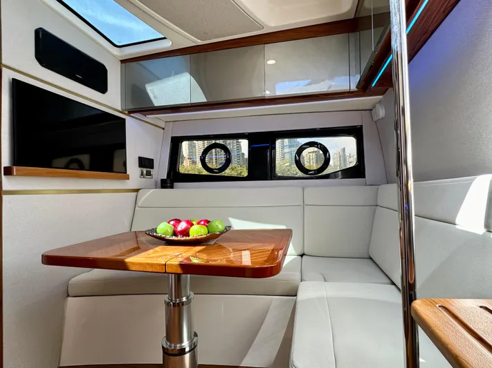 Blue Reeler Yacht Photos Pics Luxurious interior of 2023 Boston Whaler 405 Conquest with elegant seating and wooden table.