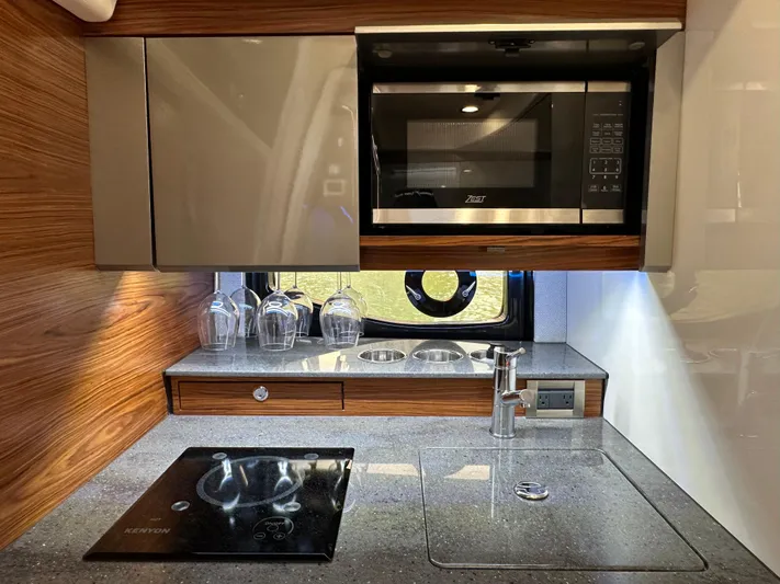 Blue Reeler Yacht Photos Pics Modern kitchen in 2023 Boston Whaler 405 Conquest with microwave, stove, and sink.