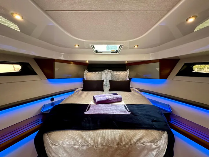 Blue Reeler Yacht Photos Pics Luxurious cabin interior of 2023 Boston Whaler 405 Conquest with ambient lighting and plush bedding.