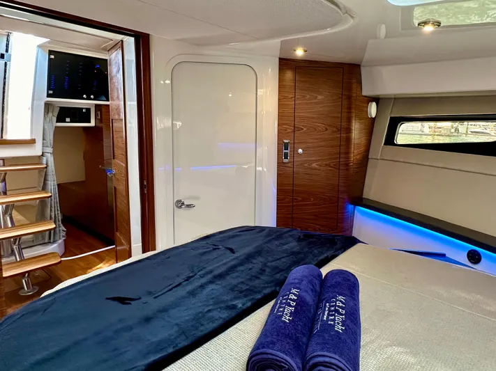 Blue Reeler Yacht Photos Pics Luxurious cabin interior of 2023 Boston Whaler 405 Conquest with elegant wood finishes.