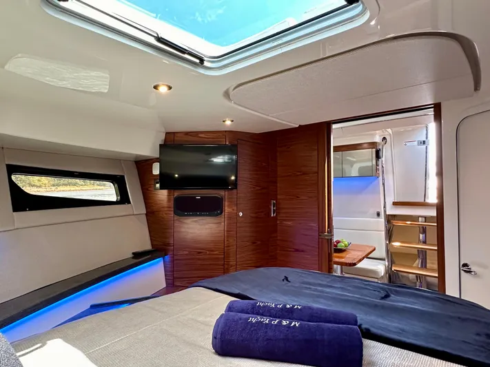 Blue Reeler Yacht Photos Pics Luxurious interior of 2023 Boston Whaler 405 Conquest yacht with skylight and modern amenities.