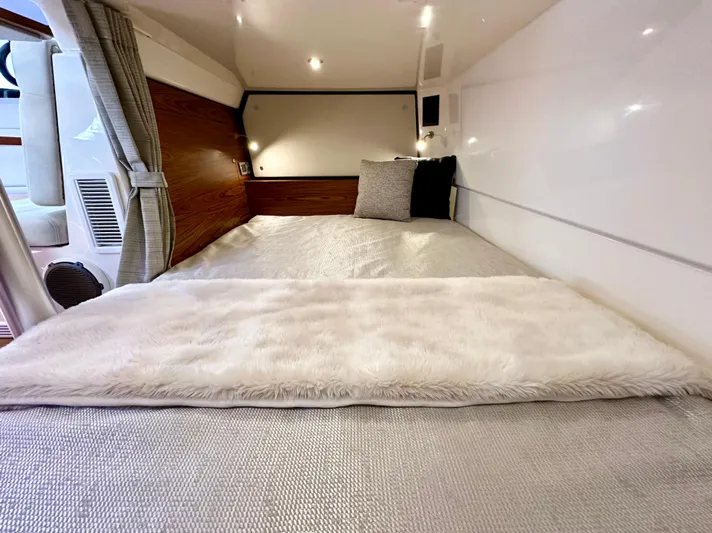 Blue Reeler Yacht Photos Pics Luxurious cabin interior of 2023 Boston Whaler 405 Conquest with cozy bedding and modern design.