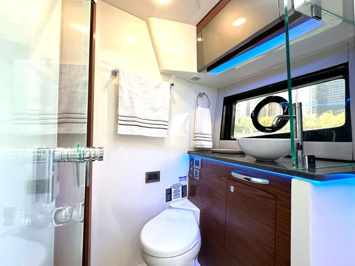 Blue Reeler Yacht Photos Pics Luxurious bathroom in 2023 Boston Whaler 405 Conquest yacht with modern fixtures and ambient lighting.