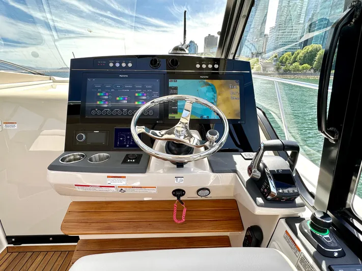 Blue Reeler Yacht Photos Pics Helm of 2023 Boston Whaler 405 Conquest with advanced navigation systems and controls.