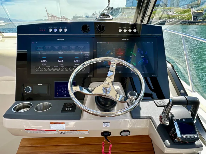 Blue Reeler Yacht Photos Pics 2023 Boston Whaler 405 Conquest helm with advanced navigation displays and controls.