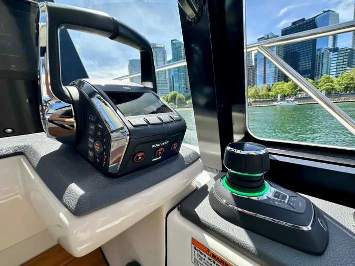 Blue Reeler Yacht Photos Pics Control panel of 2023 Boston Whaler 405 Conquest with city skyline view.