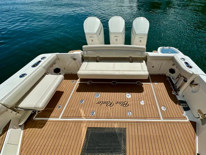 Blue Reeler Yacht Photos Pics 2023 Boston Whaler 405 Conquest boat deck with seating and triple engines.