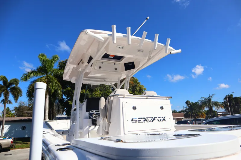  Yacht Photos Pics 2022 Sea Fox 288 Commander boat with T-top, parked under clear blue sky.