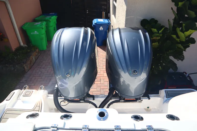  Yacht Photos Pics Twin outboard motors on a 2022 Sea Fox 288 Commander boat, parked in a driveway.