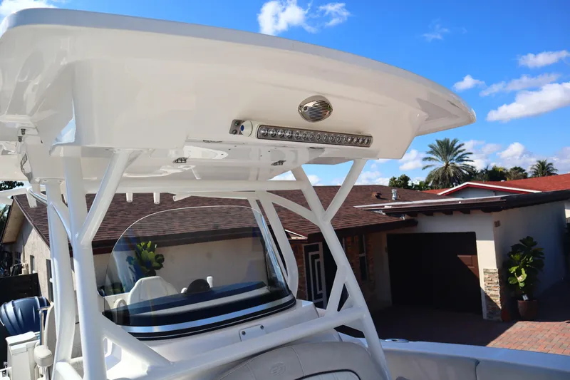  Yacht Photos Pics 2022 Sea Fox 288 Commander boat with T-top and LED lights, parked near a house.