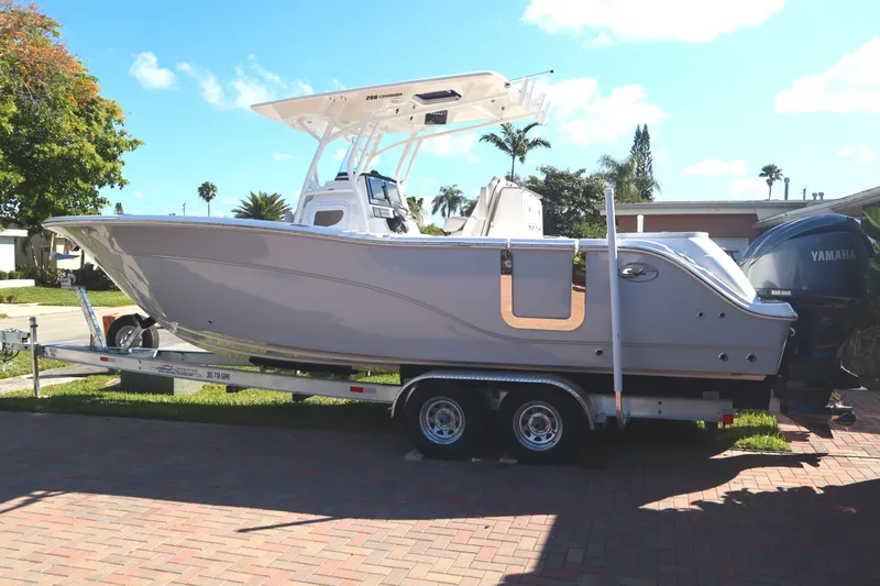  Yacht Photos Pics 2022 Sea Fox 288 Commander boat on trailer, parked outdoors under clear sky.