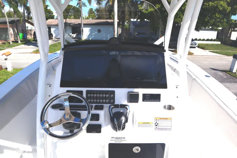  Yacht Photos Pics 2022 Sea Fox 288 Commander boat dashboard with steering wheel and controls.