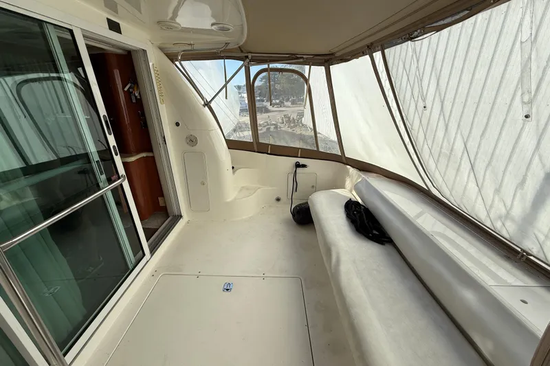  Yacht Photos Pics 1998 Sea Ray 480 Sedan Bridge interior with enclosed seating area and sliding glass door.