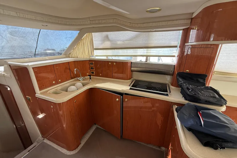  Yacht Photos Pics Luxurious 1998 Sea Ray 480 Sedan Bridge yacht kitchen with wood cabinetry and modern appliances.