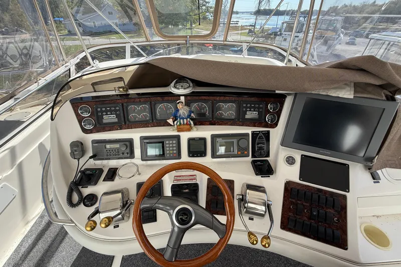  Yacht Photos Pics 1998 Sea Ray 480 Sedan Bridge helm with steering wheel, gauges, and navigation equipment.
