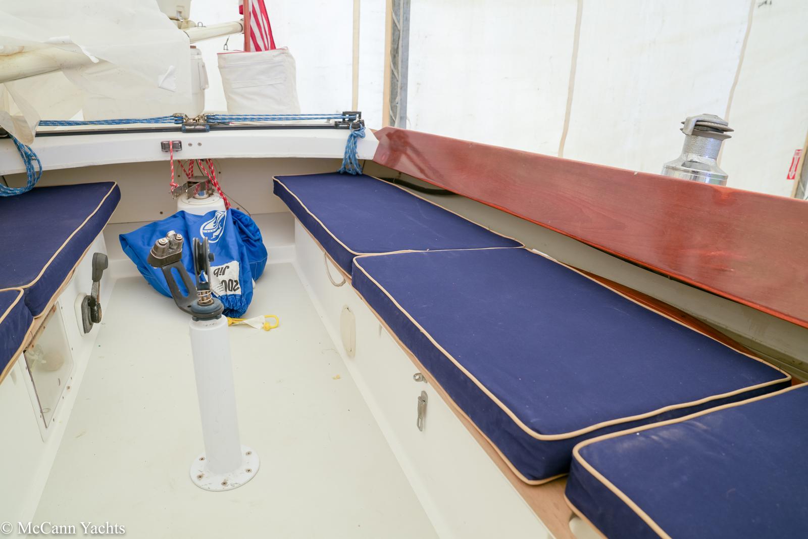 Interior of 2002 Alerion Express 28 sailboat with blue cushioned seating.