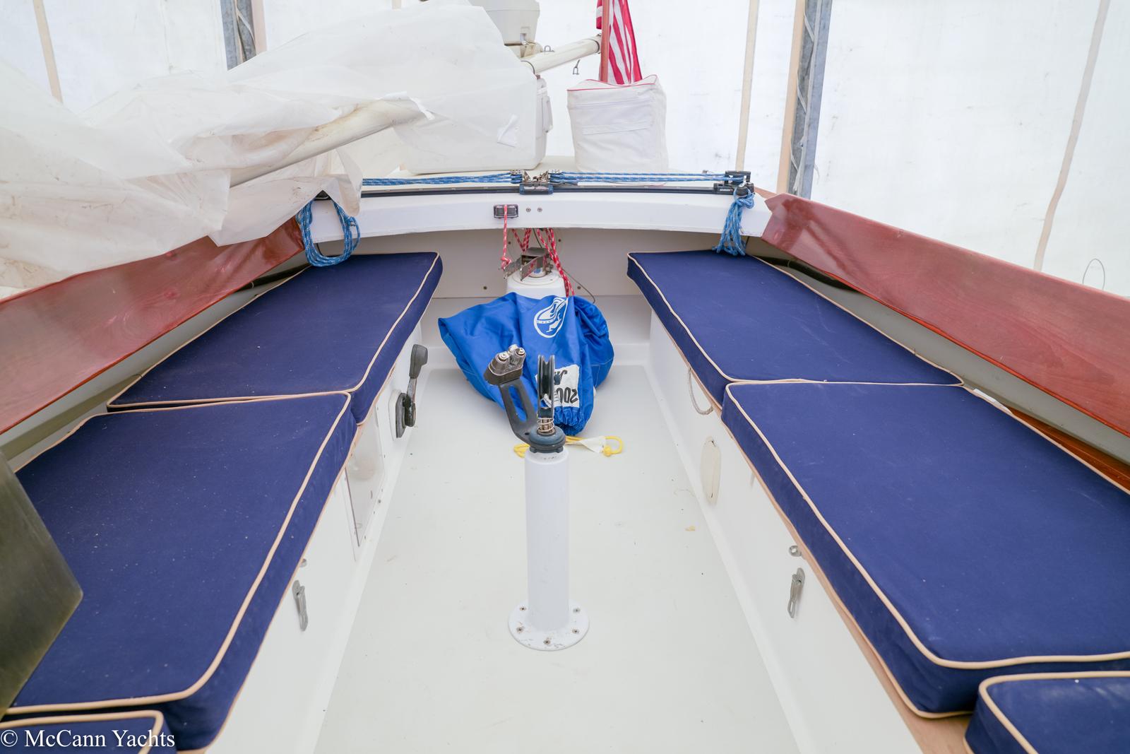 Interior of a 2002 Alerion Express 28 sailboat with blue cushioned seating.