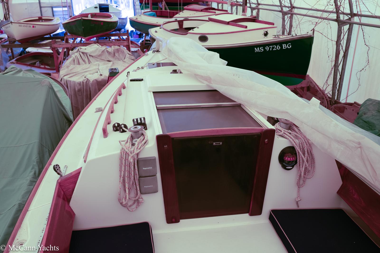 2002 Alerion Express 28 sailboat in storage, surrounded by other boats.