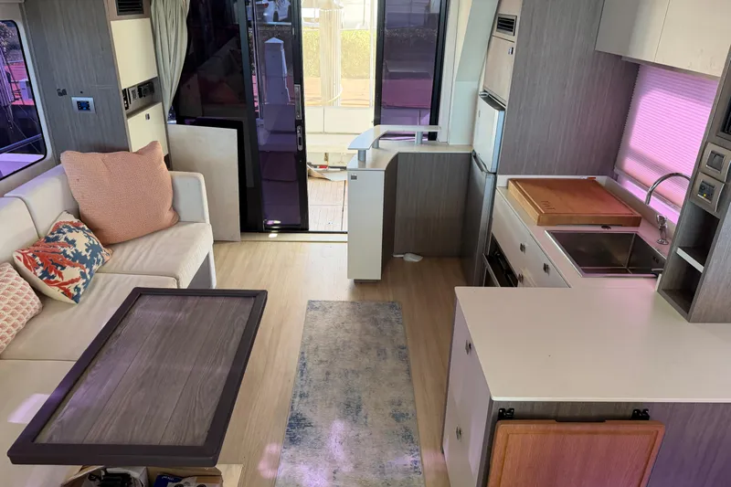  Yacht Photos Pics Modern interior of 2016 Cranchi Eco Trawler 53 Long Distance yacht with kitchen and seating area.