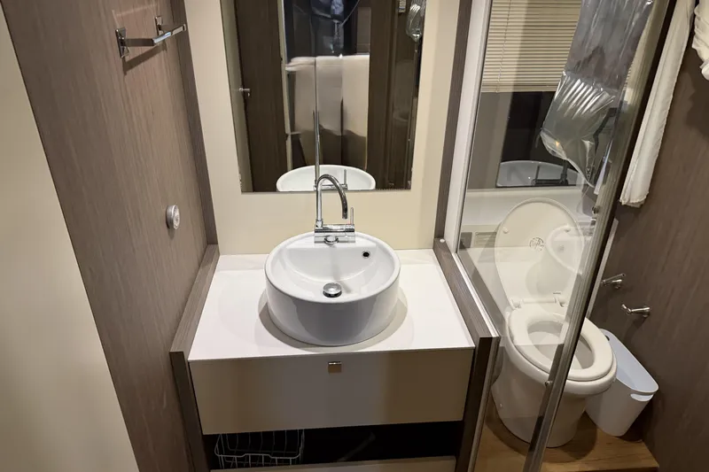  Yacht Photos Pics Bathroom interior of 2016 Cranchi Eco Trawler 53 Long Distance yacht, featuring modern sink and toilet.