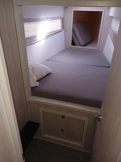 Red Robin Yacht Photos Pics Cozy cabin interior of 2019 Leopard 40 catamaran with bed and storage.