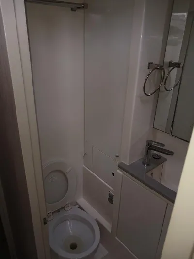 Red Robin Yacht Photos Pics Compact bathroom in 2019 Leopard 40 yacht with toilet, sink, and mirror.