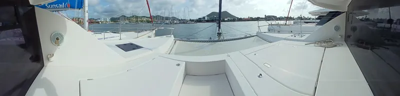 Red Robin Yacht Photos Pics Leopard 40 catamaran deck view, 2019 model, docked in a marina with scenic background.