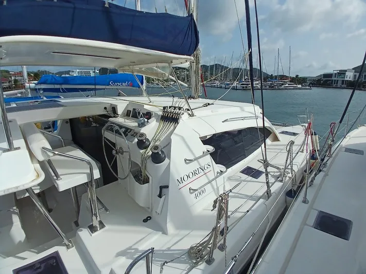 Red Robin Yacht Photos Pics 2019 Leopard 40 catamaran docked at marina, featuring spacious deck and modern design.