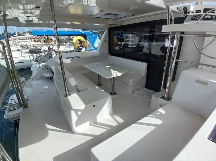Red Robin Yacht Photos Pics Spacious deck of 2019 Leopard 40 catamaran with seating and table.