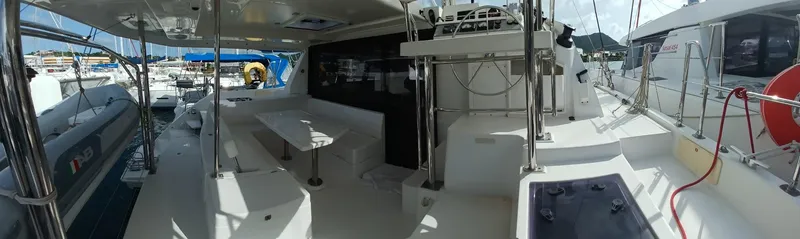 Red Robin Yacht Photos Pics 2019 Leopard 40 catamaran interior with seating and navigation area in a marina setting.