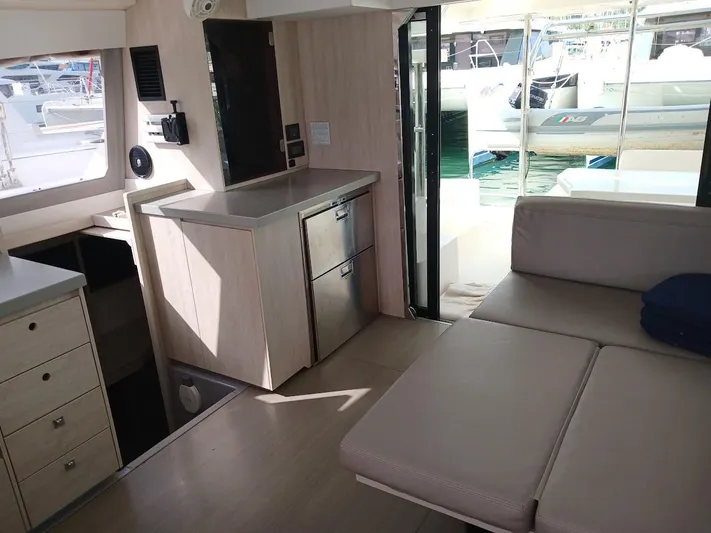 Red Robin Yacht Photos Pics Interior of 2019 Leopard 40 catamaran with modern furnishings and marina view.