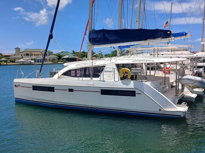 Red Robin Yacht Photos Pics 2019 Leopard 40 catamaran docked in a marina under a clear blue sky.