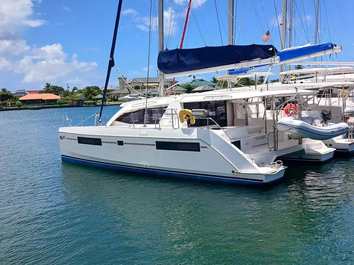 Red Robin Yacht Photos Pics 2019 Leopard 40 catamaran docked in a sunny marina.