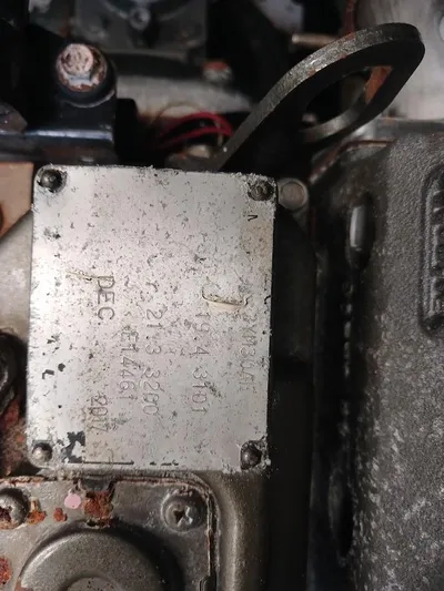 Red Robin Yacht Photos Pics Close-up of a Leopard 40 engine component, showing engraved details and wiring.