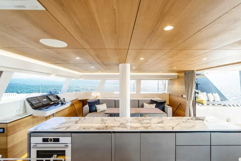 So Gnar Yacht Photos Pics Luxurious interior of 2022 Sunreef 60 Sail yacht with modern design and ocean view.