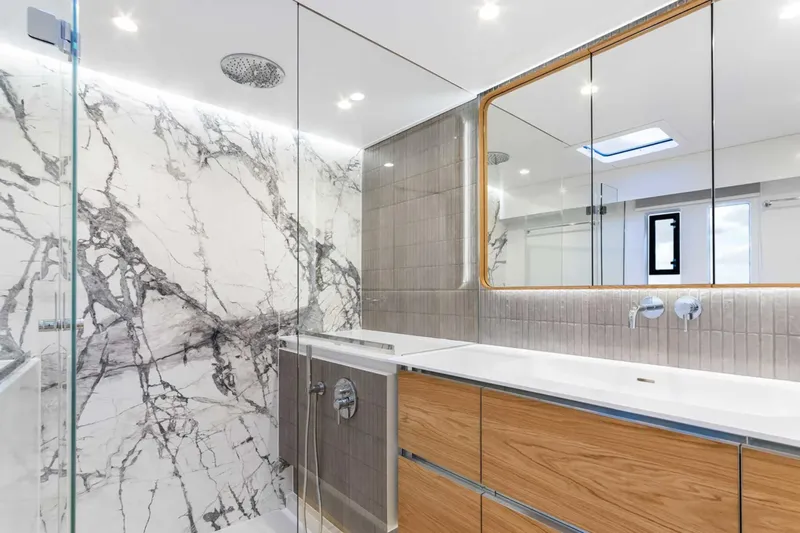 So Gnar Yacht Photos Pics Luxurious bathroom in 2022 Sunreef 60 Sail yacht with marble and wood finishes.