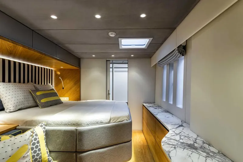 So Gnar Yacht Photos Pics Luxurious bedroom interior of 2022 Sunreef 60 Sail yacht with modern design and elegant decor.