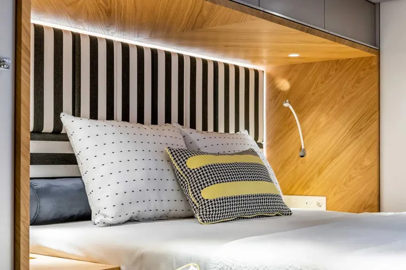 So Gnar Yacht Photos Pics Luxurious bedroom interior on 2022 Sunreef 60 Sail yacht with modern design and cozy bedding.
