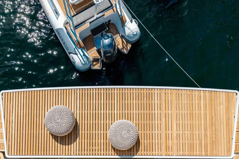 So Gnar Yacht Photos Pics Top view of 2022 Sunreef 60 Sail yacht with wooden deck and tender boat.