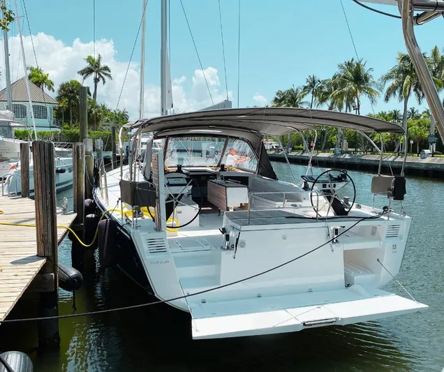 Dufour 530 In Annapolis Yacht Photos Pics 2024 Dufour 530 sailboat docked in a sunny marina with palm trees.