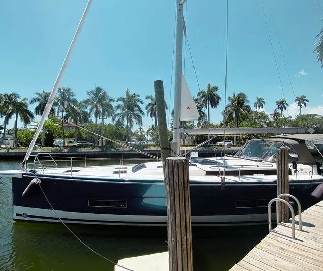 Dufour 530 In Annapolis Yacht Photos Pics 2024 Dufour 530 sailboat docked at a marina with palm trees in the background.