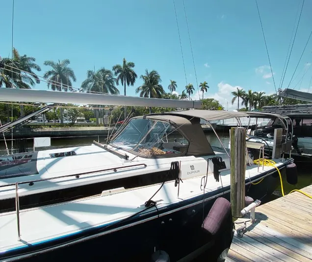 Dufour 530 In Annapolis Yacht Photos Pics 2024 Dufour 530 sailboat docked at a marina with palm trees in the background.