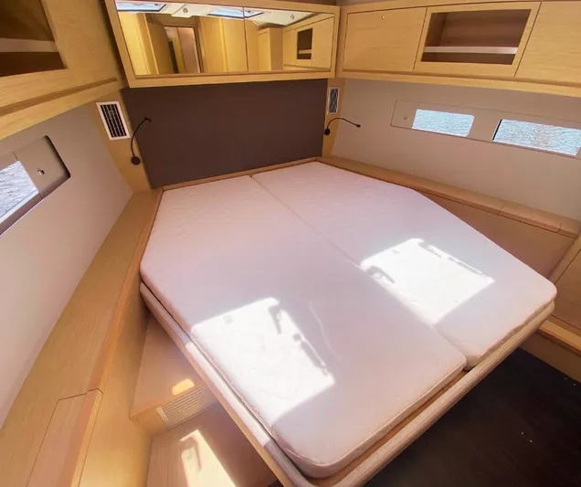 Dufour 530 In Annapolis Yacht Photos Pics 2024 Dufour 530 yacht cabin with double bed, wooden cabinetry, and natural light.