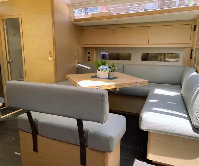 Dufour 530 In Annapolis Yacht Photos Pics Modern interior of 2024 Dufour 530 yacht with light wood finishes and cozy seating area.