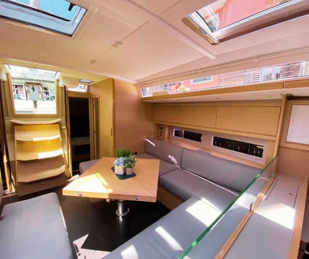 Dufour 530 In Annapolis Yacht Photos Pics Modern interior of 2024 Dufour 530 yacht with skylights and cozy seating area.